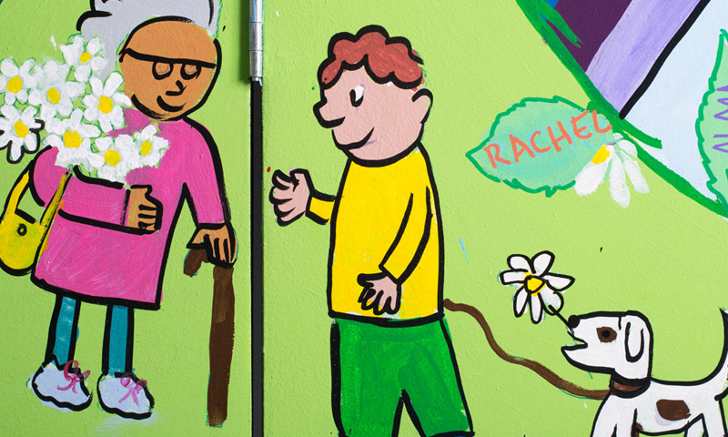 A person with flowers and a child with a dog 