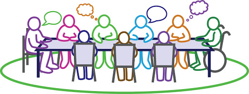 group of people sitting around a conference table speaking