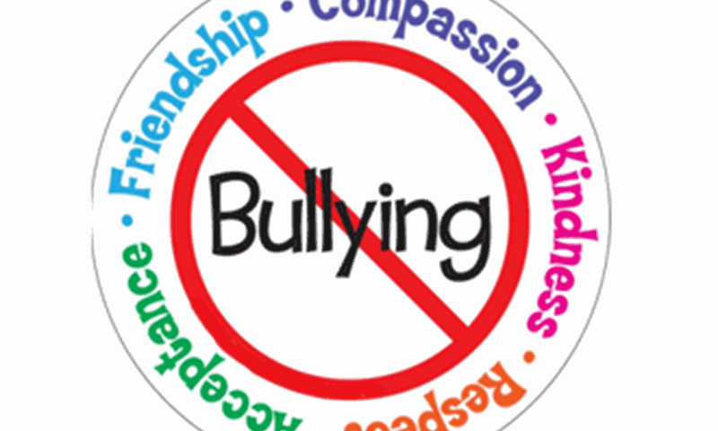 A red circle with a line through it, scoring out the word 'Bullying'. Written around the circle are the words 'Compassion, kindness, respect, acceptance, friendship.'