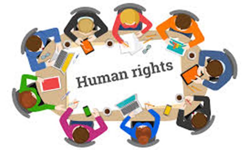 people around a table with 'human rights' written on the table