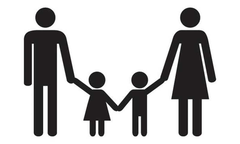 Black mannequins against a white background. A family of four, the adults are holding the children's hands.